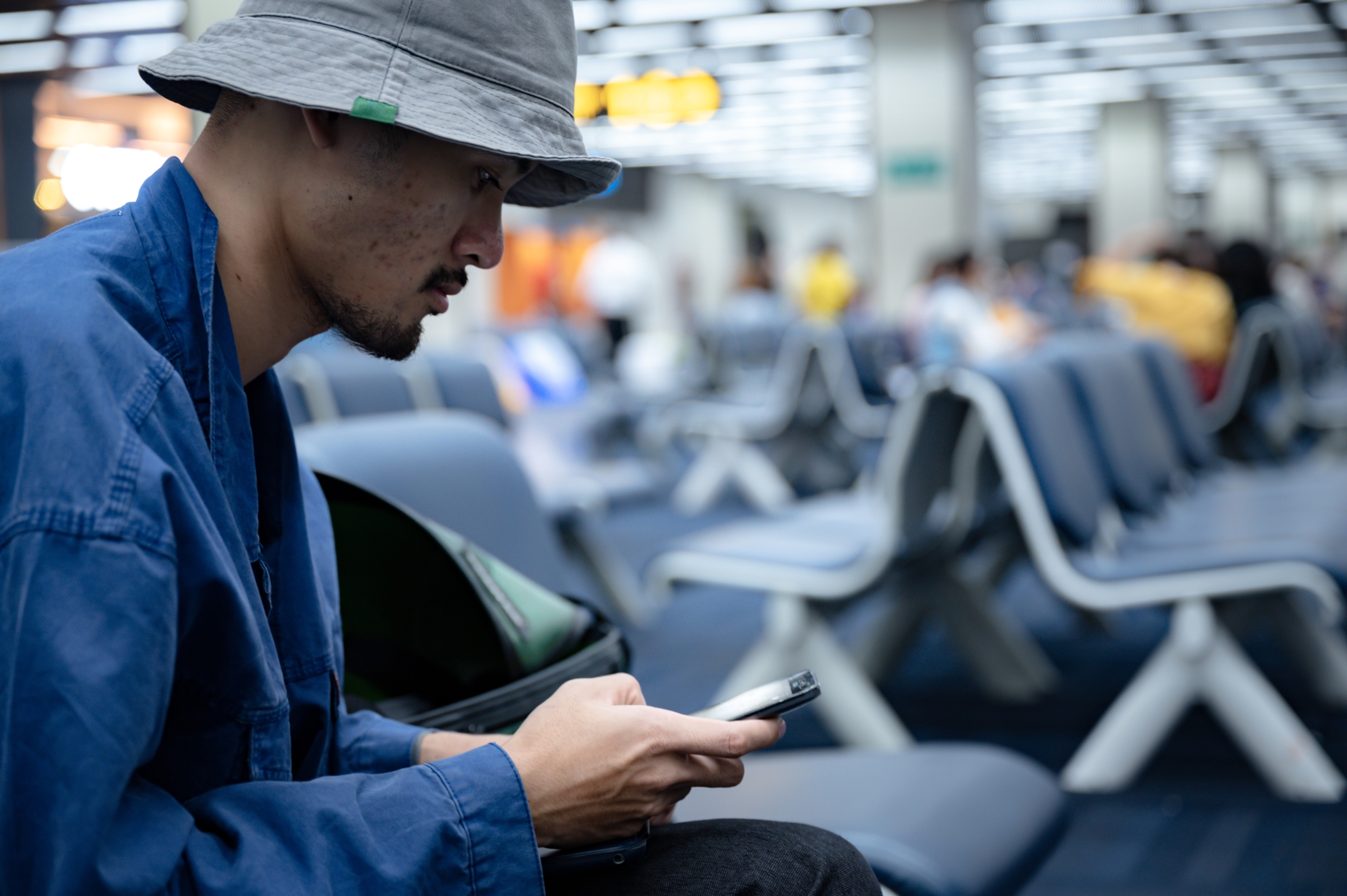 departure person using a phone in aerodrome airport terminal