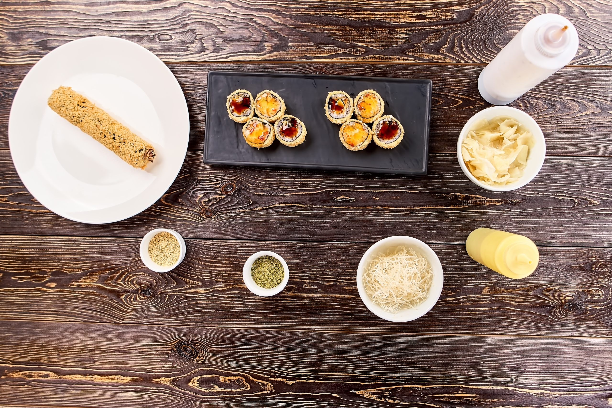 Cut and uncut rolls unagi furay and side dish.